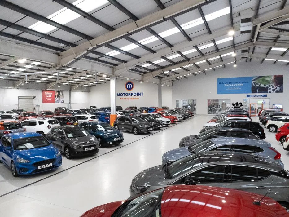 Motorpoint Swansea showroom with rows of vehicles and a light grey coated floor