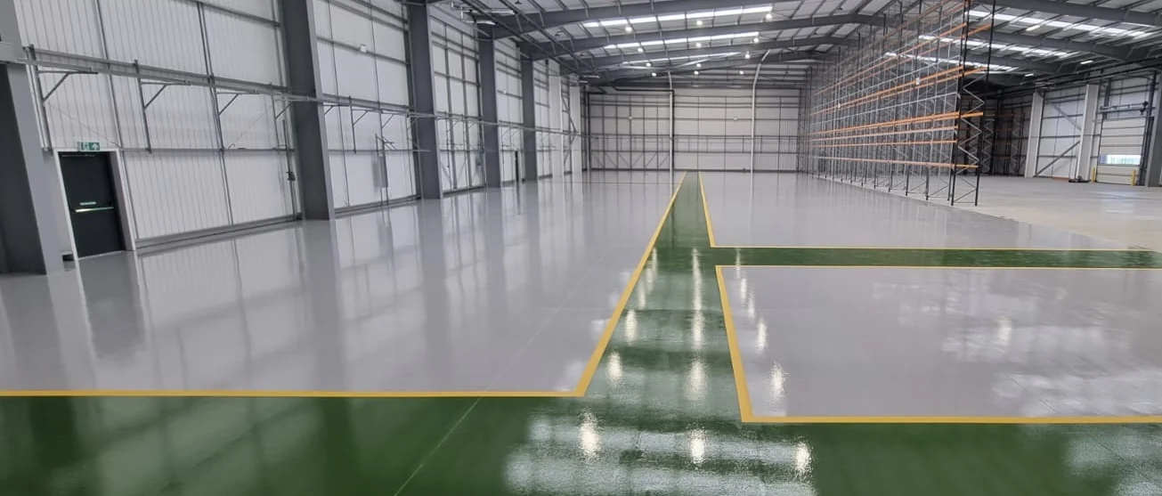 Trimark warehouse in Coalville with a light grey coated floor, green pedestrian walkways and yellow boundary lines